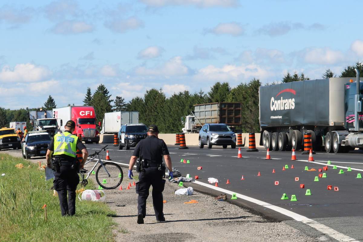 Police at the scene of a fatal collision on Highway 401 involving a cyclist and a vehicle in the eastbound lane near Colonel Talbot Road, London. August 11, 2022