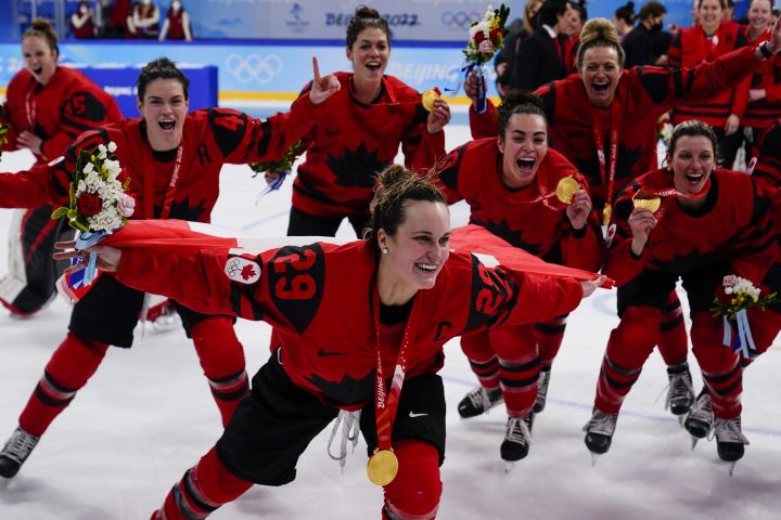 Canada's Marie-Philip Poulin (29) celebrates with her gold medal after the women's gold medal hockey game at the 2022 Winter Olympics, Thursday, Feb. 17, 2022, in Beijing. 