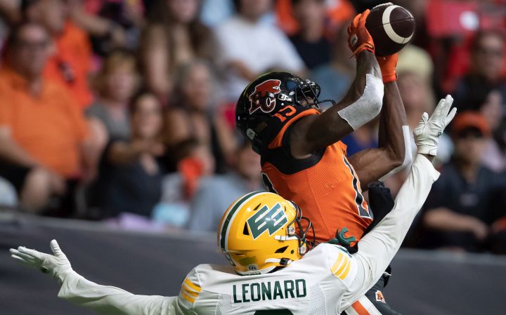 B.C. Lions’ Dominique Rhymes, back, makes a touchdown reception in the end zone as Edmonton Elks’ Raphael Leonard defends during the first half of CFL football game in Vancouver, on Saturday, August 6, 2022.