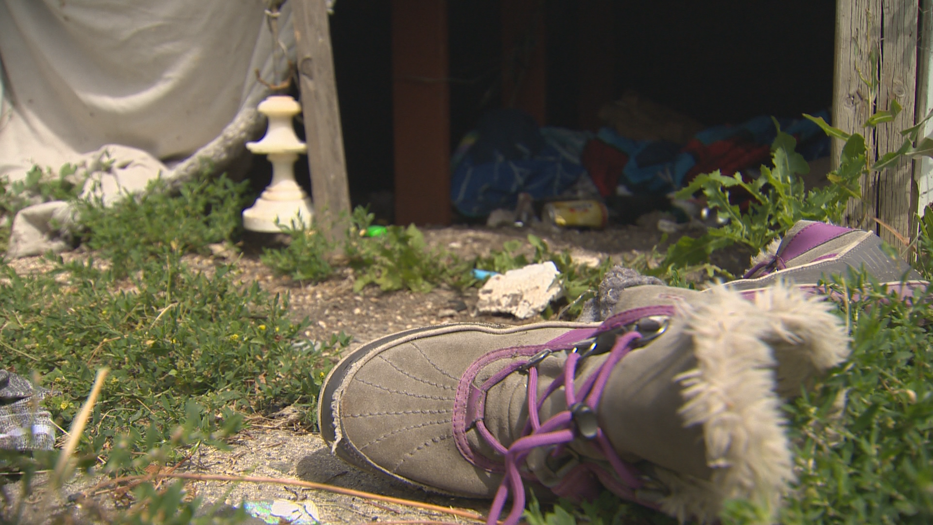 Remnants of clothing and garbage left behind from squatters at a vacant building.