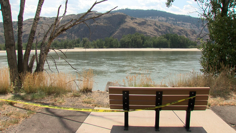 Police tape near where witnesses say the missing man entered the water to save a child.