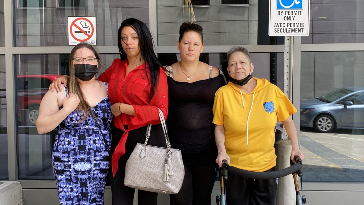 Dhelia Baldwin, Jessica O'Neill, Laura Erie and Olga Tomchuk stand together outside the John Sopinka Courthouse.