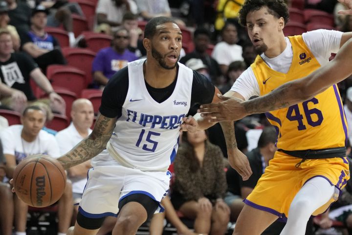 Los Angeles Clippers' Xavier Moon drives around Los Angeles Lakers' Javante McCoy during the second half an NBA summer league basketball game Tuesday, July 12, 2022, in Las Vegas. 