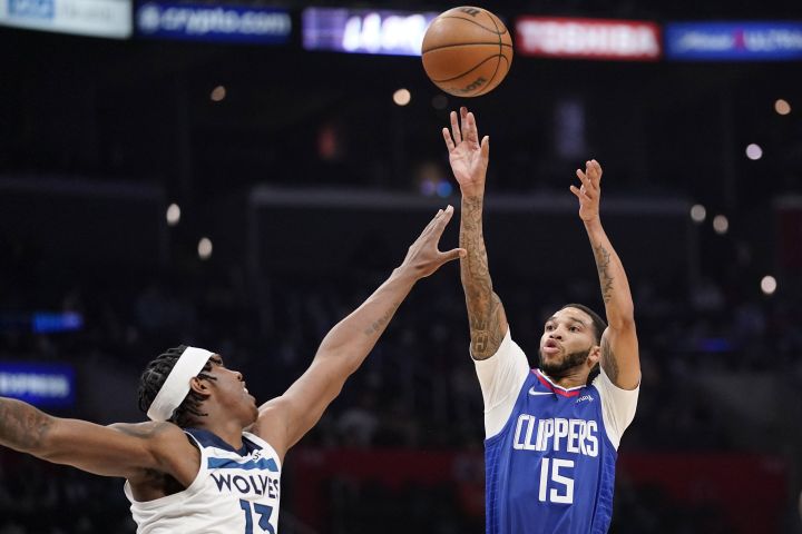 Los Angeles Clippers guard Xavier Moon, shoots as Minnesota Timberwolves forward Nathan Knight defends during the second half of an NBA basketball game Monday, Jan. 3, 2022, in Los Angeles.