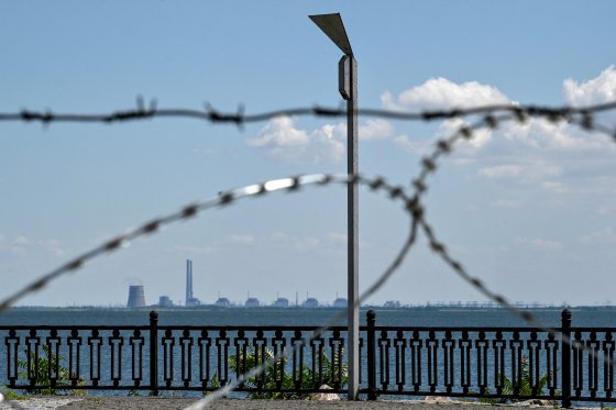 The Zaporizhzhia nuclear power plant in Ukraine is seen through barbed wire.