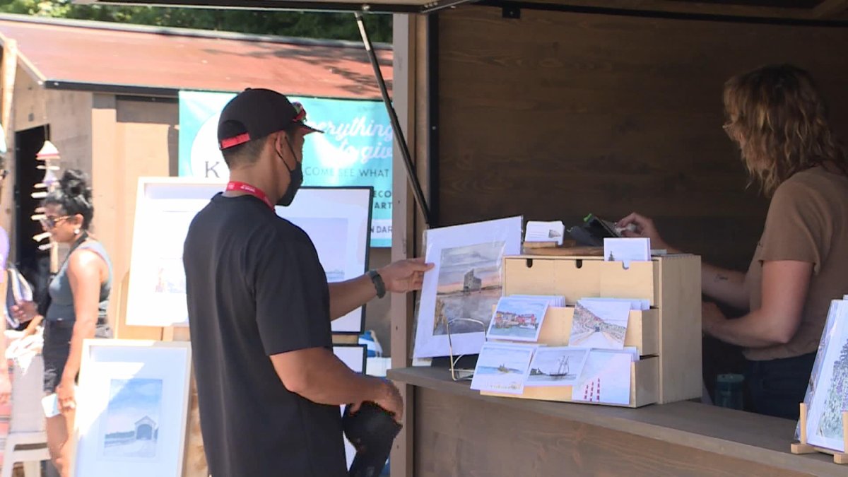 A visitor looks at a local artists prints.