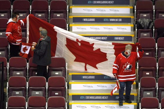 The Hockey Canada flag hands unevenly in the stands of a Word Junior game.