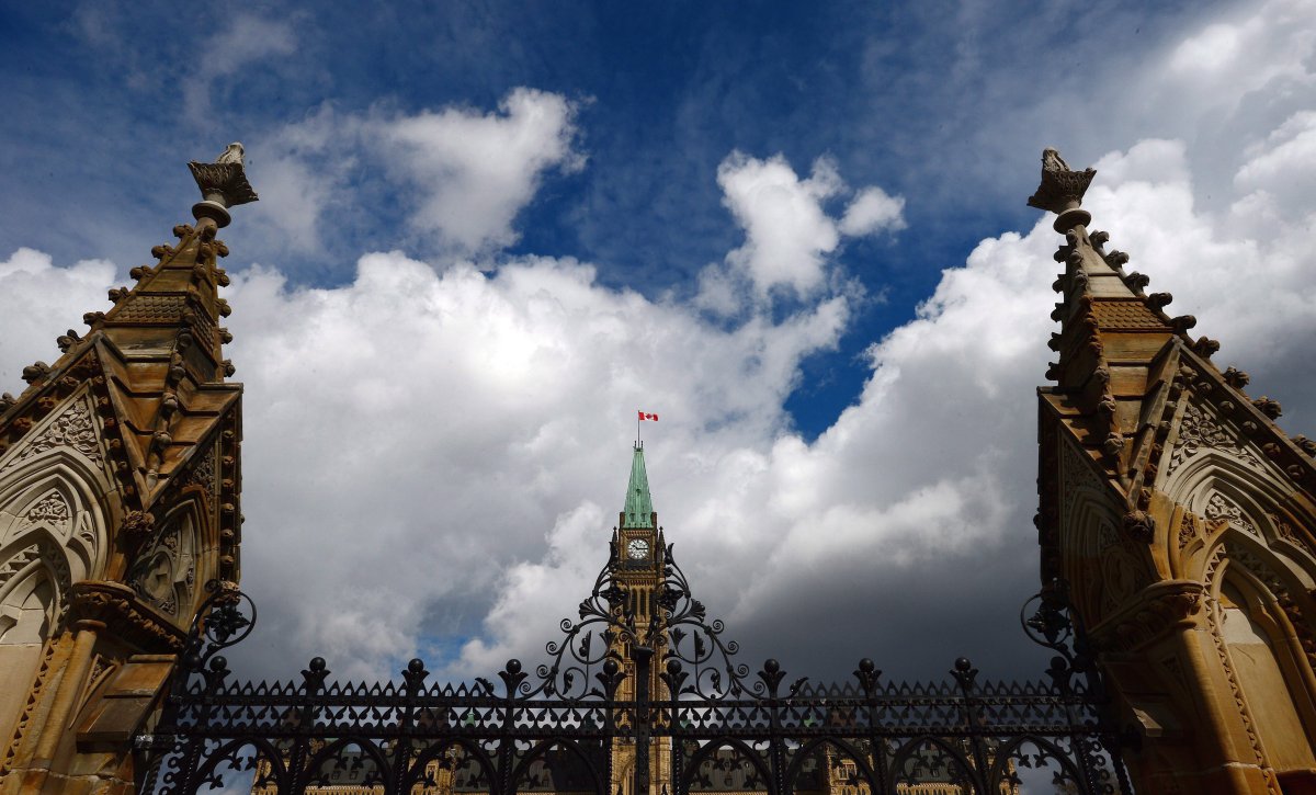 The gates of Parliament Hill are seen against a cloudy sky.