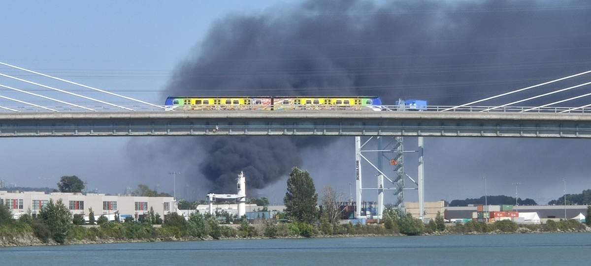 Smoke pours from a fire at a recycling facility on Mitchell Island on Wednesday.