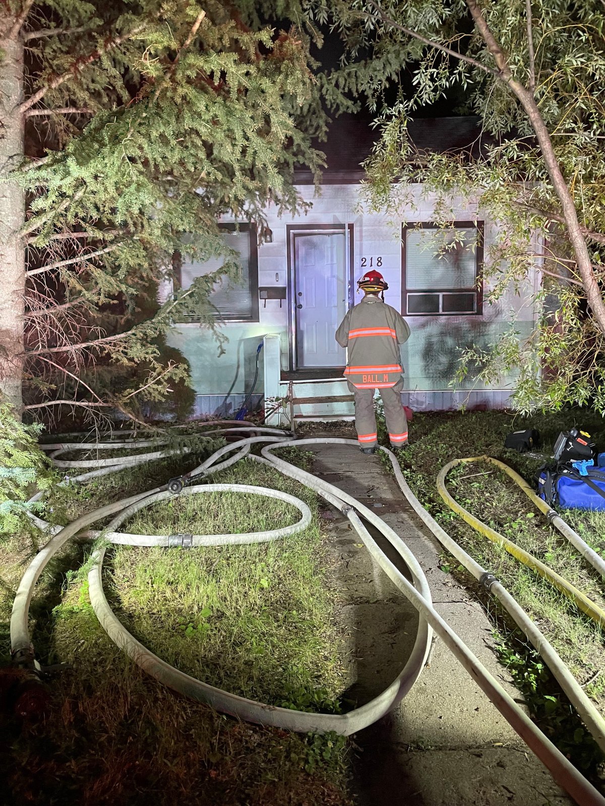 A woman was taken to hospital in Saskatoon on Sunday night after firefighters discovered her in the bedroom of a house that had a fire in the stairwell.