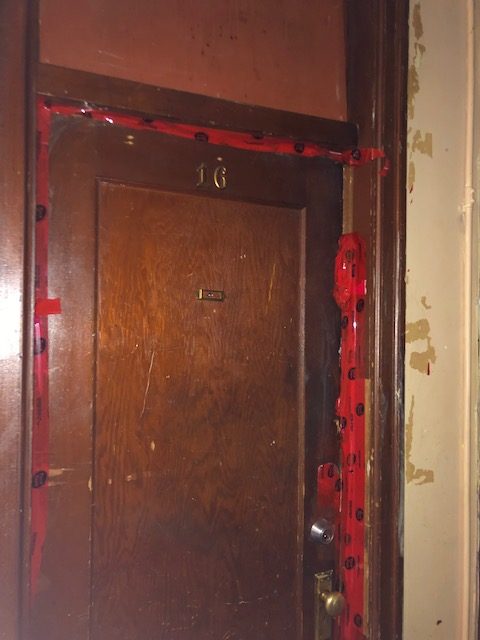 Unit #16 of The Heatley Block, where the remains of three people were discovered in as many months, remains sealed off.