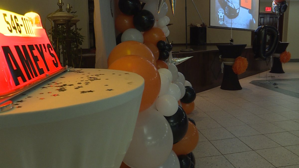 picture of ballons and an Amey's taxi sign at the 100 years in business celebration.