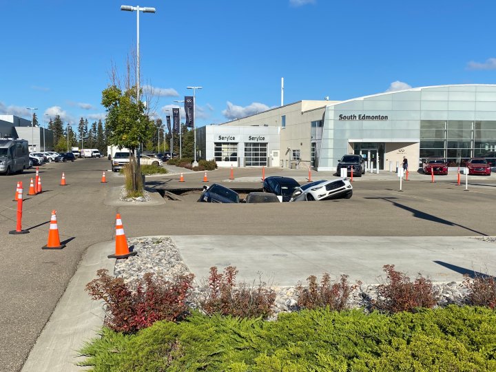 Sinkhole swallows several cars at south Edmonton dealership Edmonton