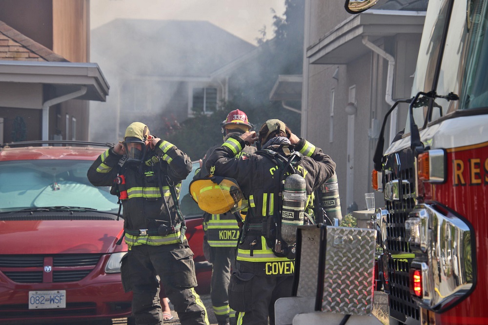 Firefighters deploy to a house fire in Surrey on Monday. 