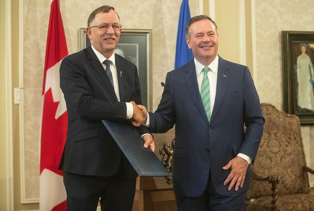 Ron Orr shakes hands with Alberta Premier Jason Kenney during a cabinet shuffle at Government House in Edmonton on July 8, 2021.