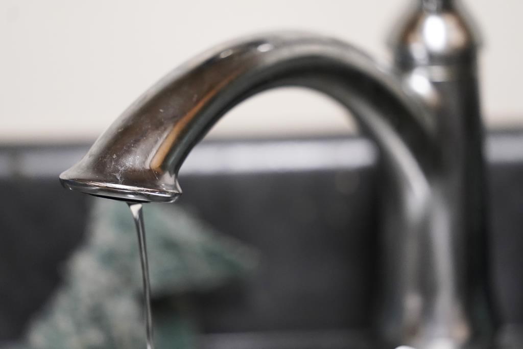 Close-up of a faucet with a trickle of water coming out.