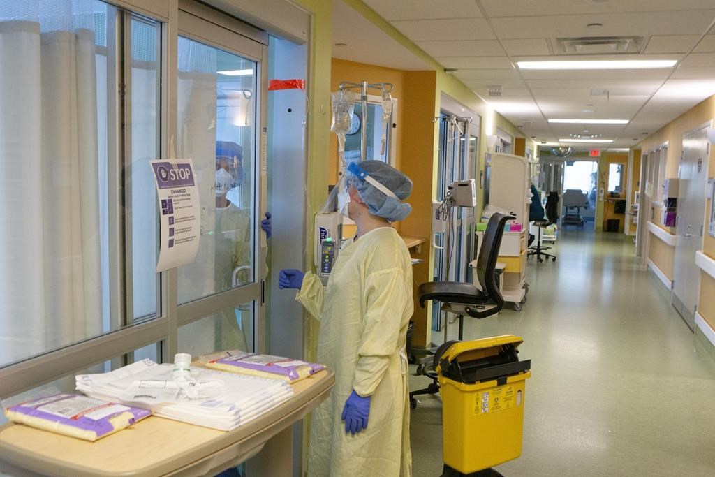 Nurses tend to a COVID-19 patient in the Intensive Care Unit at the Bluewater Health Hospital in Sarnia, Ont., on Tuesday, January 25, 2022. THE CANADIAN PRESS/Chris Young.