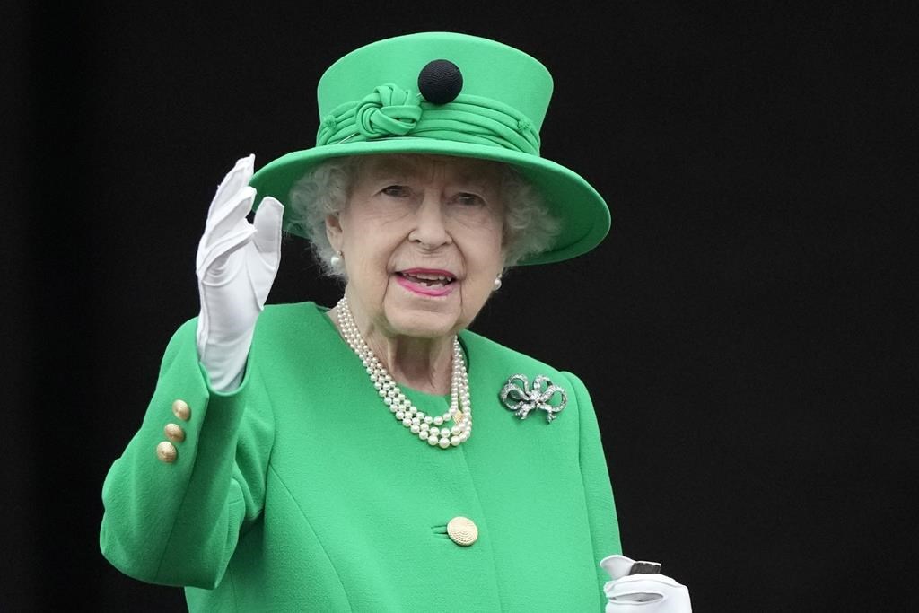 Queen Elizabeth II waves to the crowd during the Platinum Jubilee Pageant at the Buckingham Palace in London, Sunday, June 5, 2022.