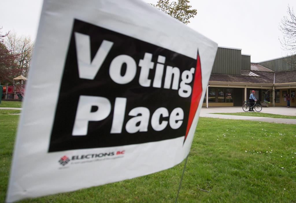 A voter arrives at a polling station on a bike to cast their ballot in the provincial election in the riding of Vancouver-Fraserview, in Vancouver on Tuesday May 9, 2017.