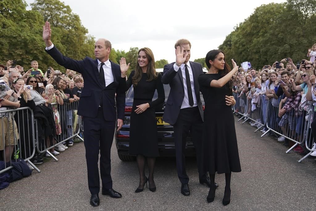 From left, Britain's Prince William, Prince of Wales, Kate, Princess of Wales, Prince Harry and Meghan, Duchess of Sussex wave to members of the public at Windsor Castle, following the death of Queen Elizabeth II on Thursday, in Windsor, England, Saturday, Sept. 10, 2022.