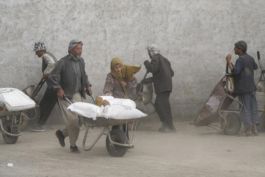 FILE - People receive food rations in Kabul, Afghanistan, May 10, 2022.