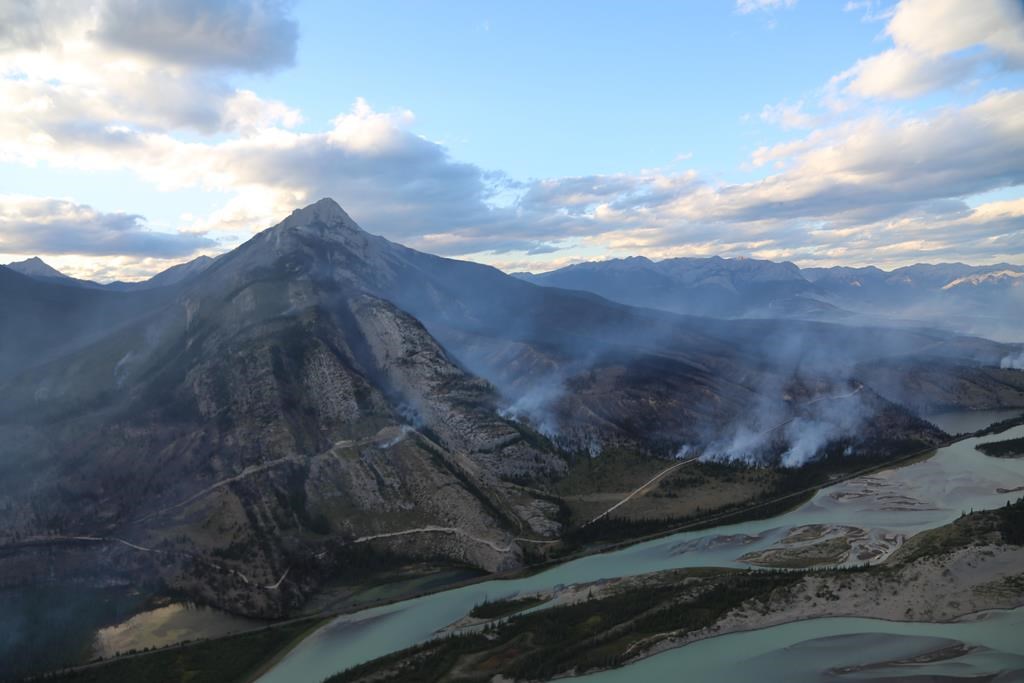 The Chetamon wildfire is seen burning beside Mount Greenock, left, in Jasper National Park in a Sept. 7, 2022, handout photo. 
