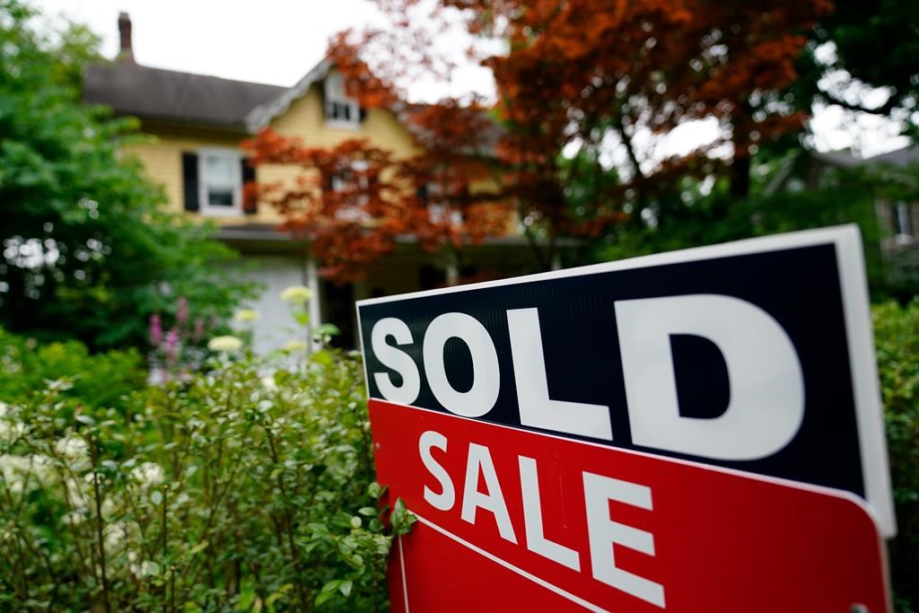 A sale sign stands outside a home in Wyndmoor, Pa., Wednesday, June 22, 2022.