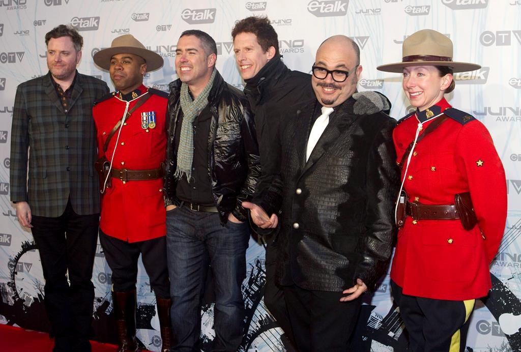 The Barenaked Ladies pose with two Mounties on the red carpet at the 2011 JUNO Awards in Toronto on Sunday, March 27, 2011.