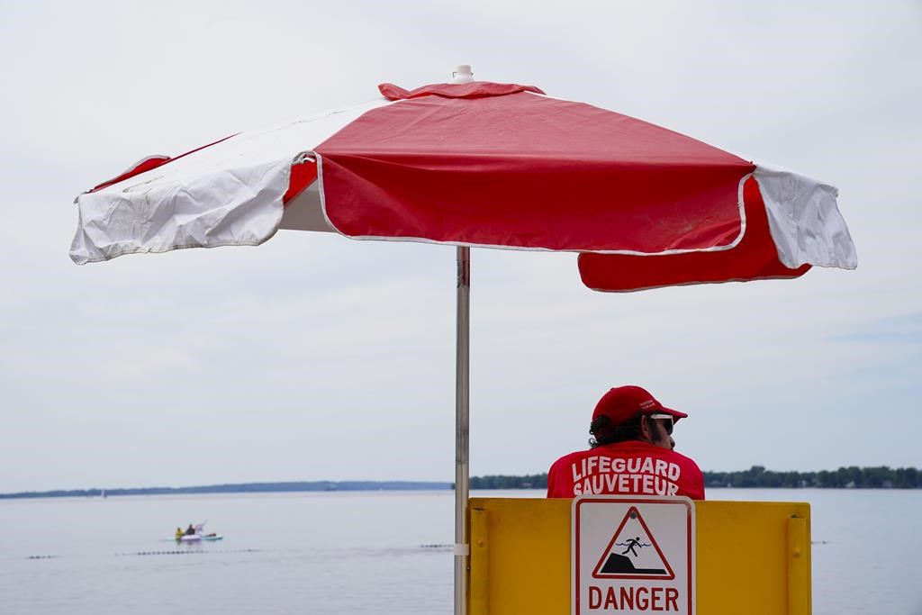 Lifeguards work at Brittany Beach of the Ottawa River in Ottawa on Friday, June 24, 2022.