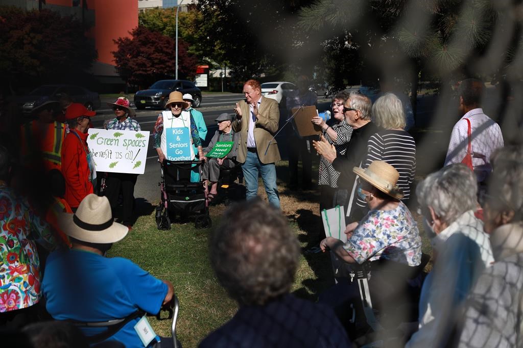 Terry Dance-Bennink speaks to seniors during a rally in support of a senior-friendly park at the former S.J. Willis Junior High School field in Victoria, B.C., on Tues. Sept. 27, 2022.
