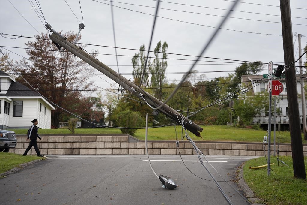 A snapped power pole hangs over a street in New Glasgow, N.S. on Wednesday, Sept. 28, 2022 following significant damage brought by post tropical storm Fiona.