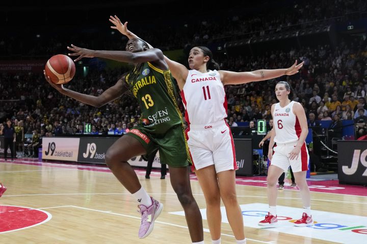 Australia's Ezi Magbegor shoots for goal as Canada's Natalie Achonwa attempts two block during their game at the women's Basketball World Cup in Sydney, Australia, Monday, Sept. 26, 2022. 