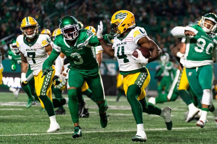 Edmonton Elks running back Kevin Brown (4) runs the football as Saskatchewan Roughriders defensive back Nick Marshall (3) chases during the first half of CFL football action at Mosaic Stadium in Regina, Sask., on Friday, September 16, 2022.