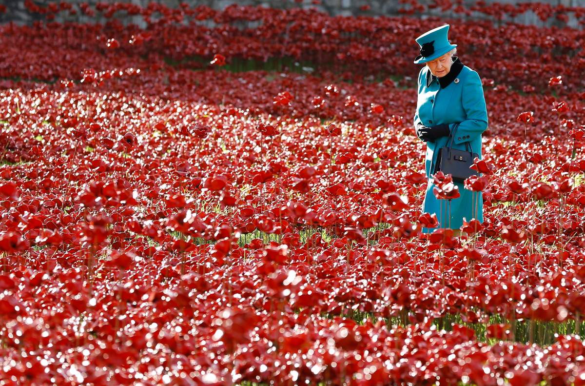 Queen Elizabeth II walks through a field of ceramic poppies at The Tower of London in 2014.