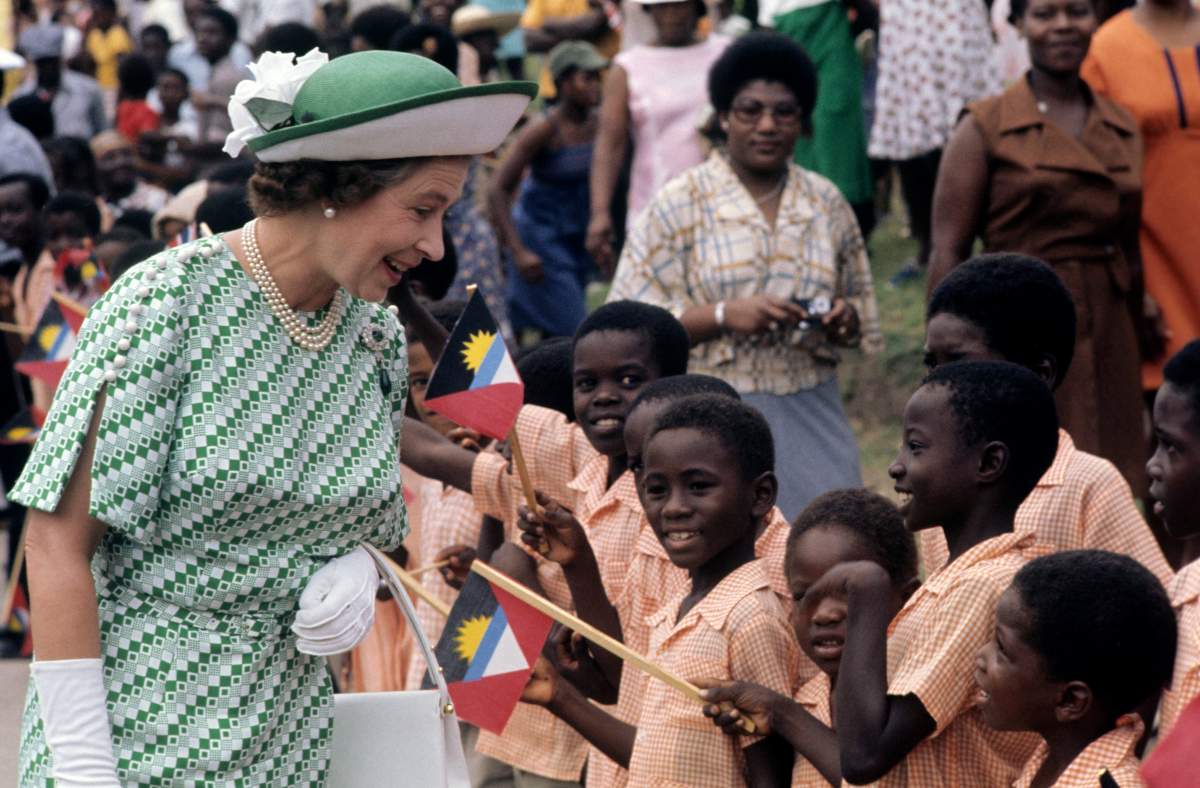 Queen Elizabeth II greets children during a walkabout on Antigua, during of her Silver Jubilee tour of the Caribbean in 1977.