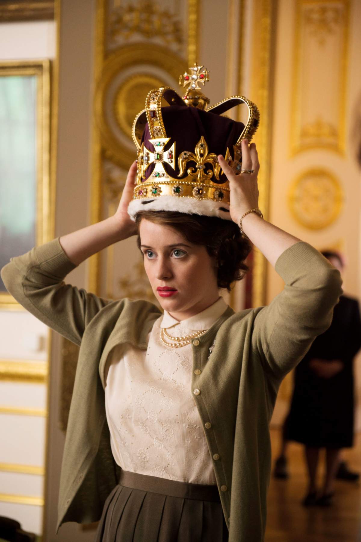 Claire Foy as Queen Elizabeth II with a crown on her head.