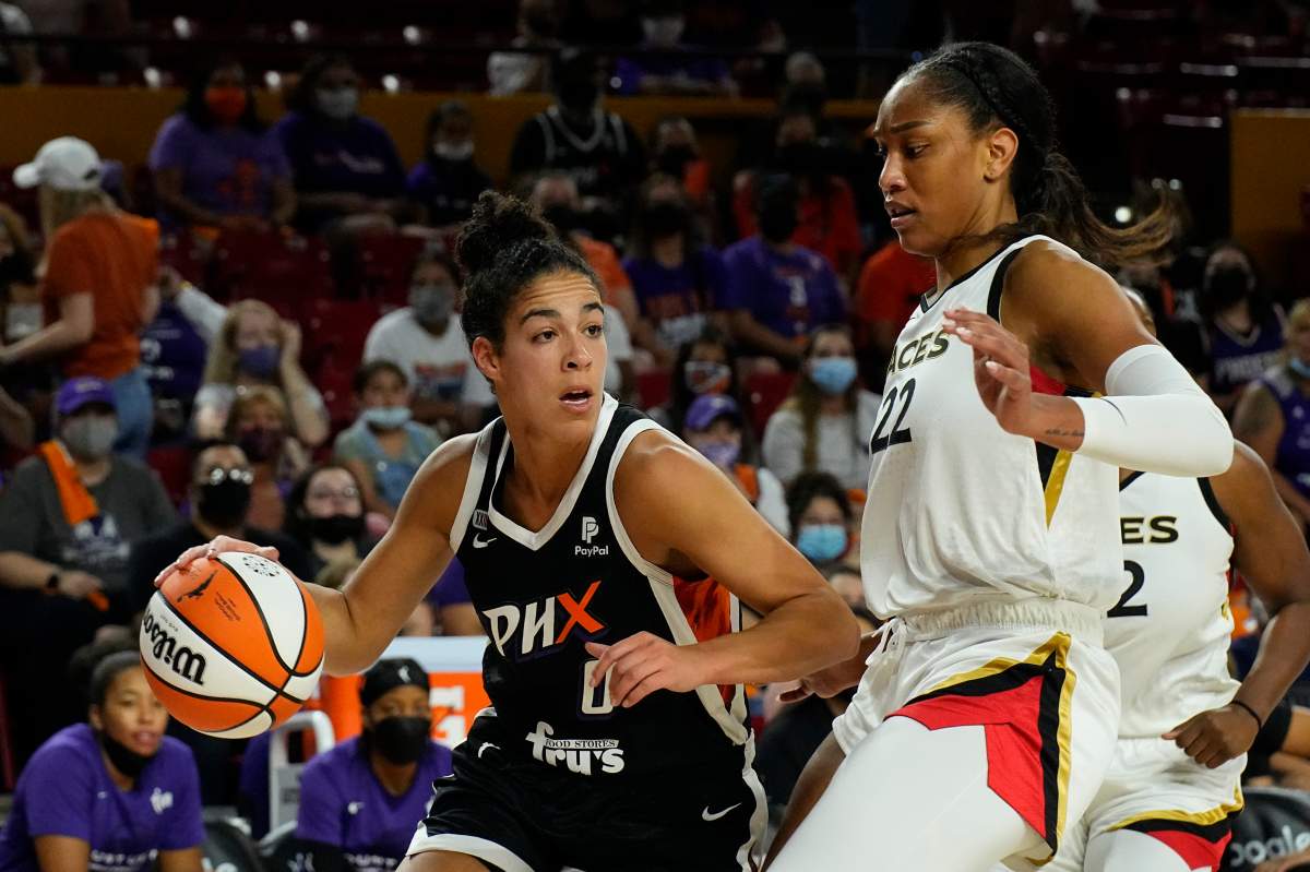 Phoenix Mercury guard Kia Nurse (0) drives on Las Vegas Aces forward A'ja Wilson during the first half of a WNBA basketball game Sunday, Oct. 3, 2021, in Phoenix. THE CANADIAN PRESS/AP-Rick Scuteri.