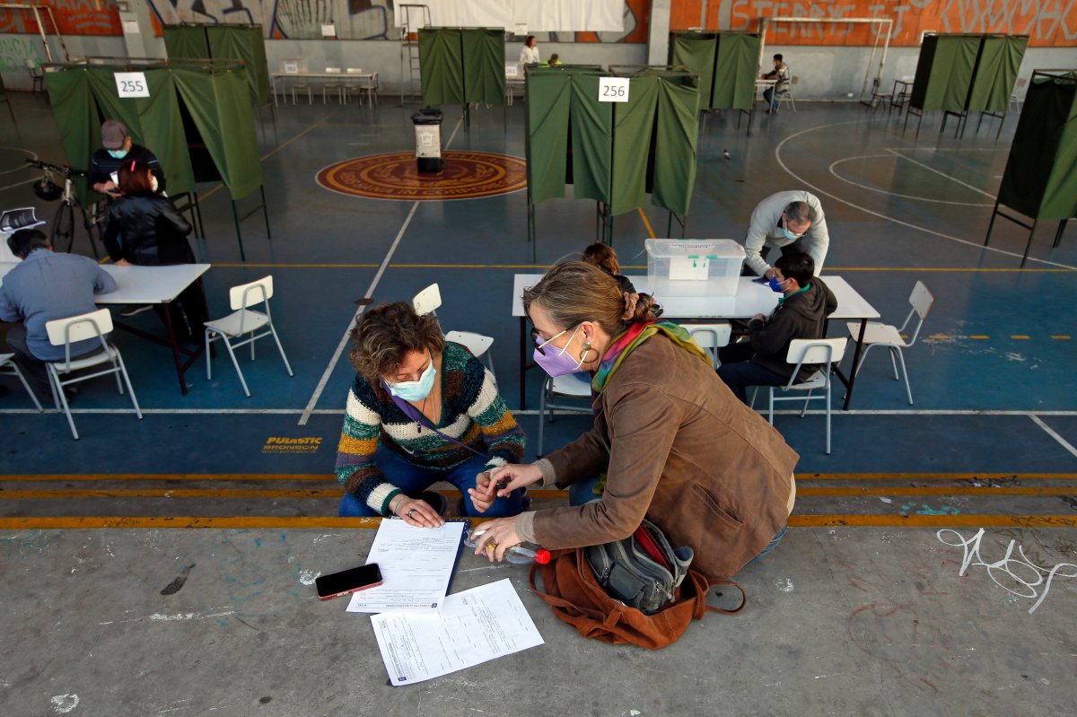 Poll workers prepare for a referendum vote on the draft of a new constitution, at a polling station in Santiago, Chile. Voters go to the polls Sunday to ratify a new constitution to reject the current constitution that was imposed by the Augusto Pinochet military dictatorship 41 years ago.