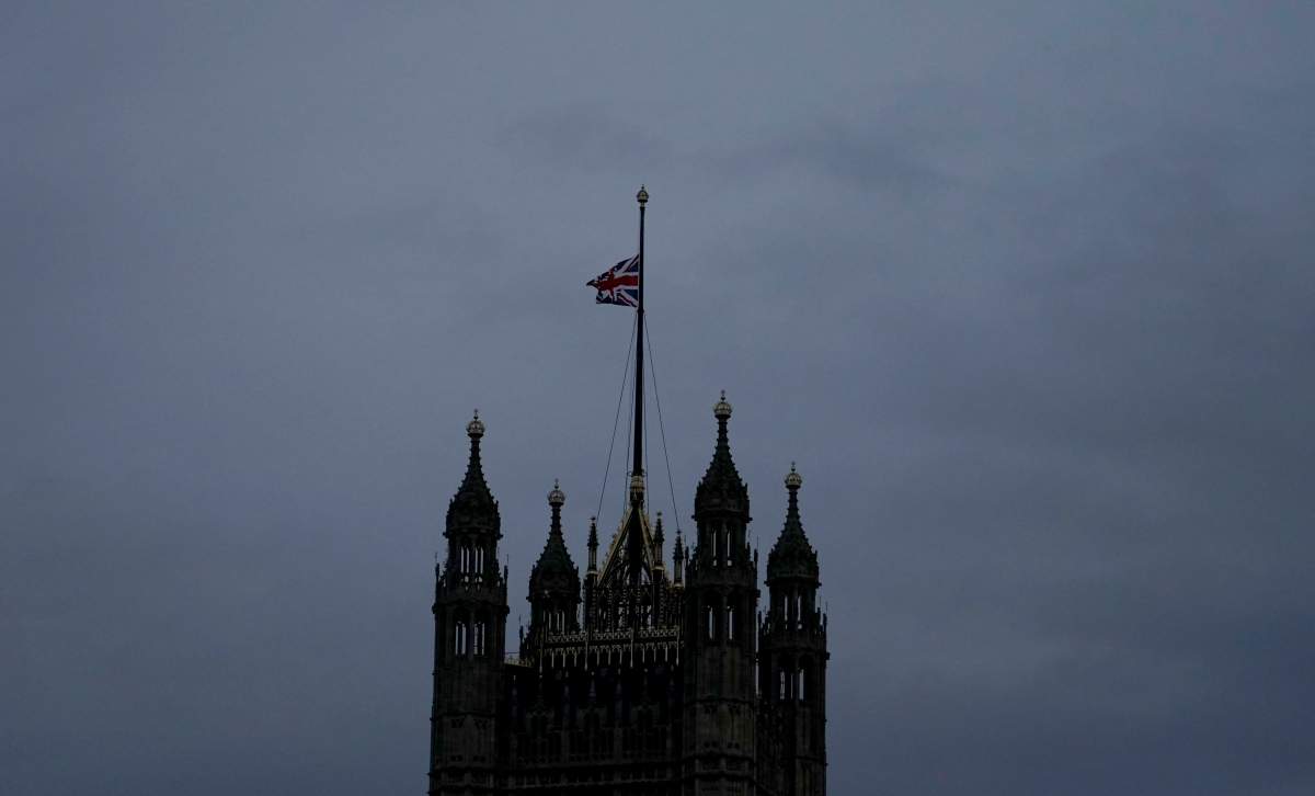 The Union flag is lowered on the Palace of Westminster in London after the death of Queen Elizabeth II, Thursday, Sept. 8, 2022. (AP Photo/Alberto Pezzali)