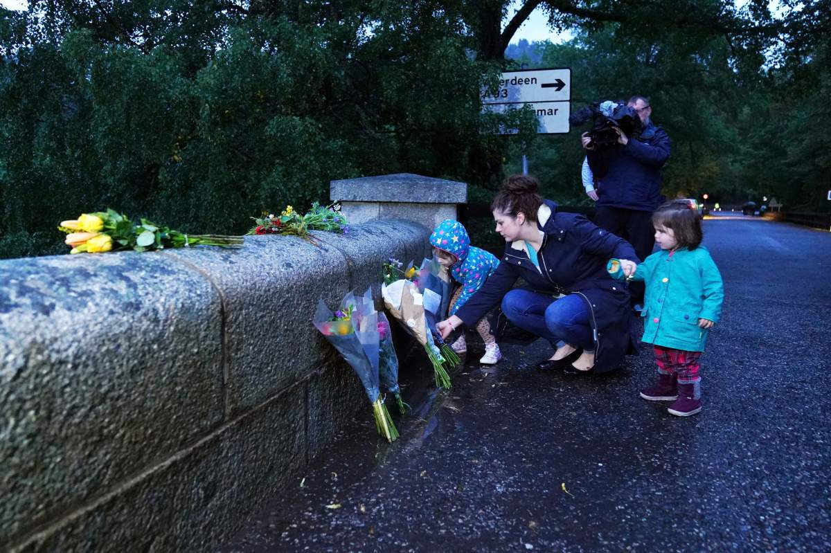 Flowers are left outside Balmoral in Scotland, Thursday, Sept. 8, 2022, following the announcement of the death of Queen Elizabeth II. (Andrew Milligan/PA via AP)