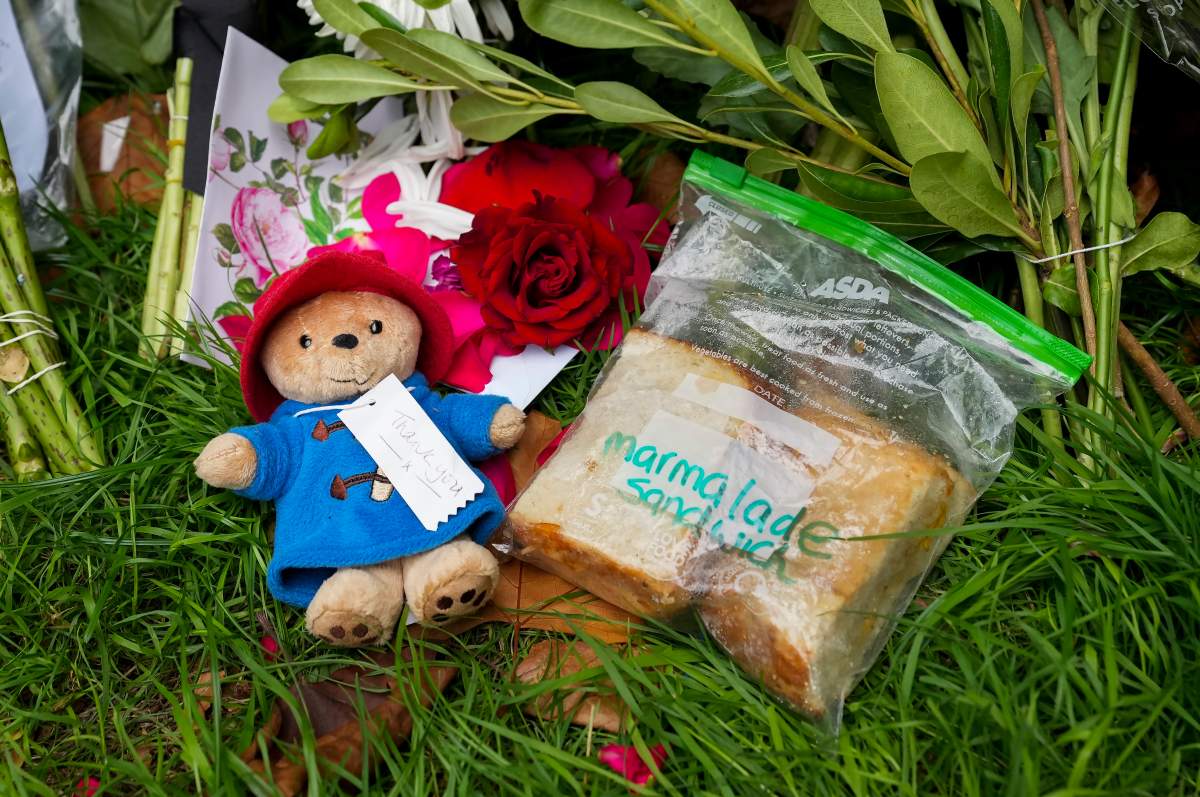 People leave different items and flowers to pay their respects near the gates of Buckingham Palace in London on Sunday, September 11, 2022. Queen Elizabeth II, Britain’s longest-reigning monarch and a rock of stability across much of a turbulent century, died Thursday Sept. 8, 2022, after 70 years on the throne. She was 96.