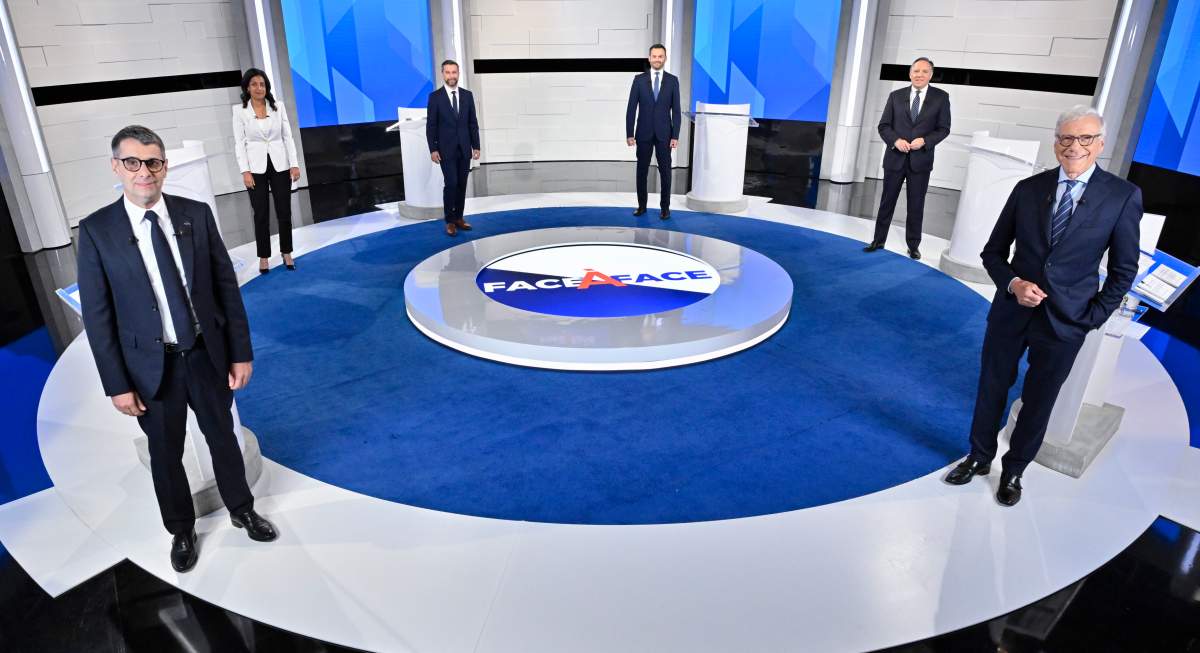 Conservative Leader Eric Duhaime, Liberal Leader Dominique Anglade, Quebec Solidaire co-spokesperson Gabriel Nadeau-Dubois, Parti-Quebecois Leader Paul St-Pierre Plamondon, CAQ Leader Francois Legault and moderator Pierre Bruneau, left to right, stand on the set prior to the leaders debate in Montreal, on Thursday, September 15, 2022. THE CANADIAN PRESS/POOL/Martin Chevalier