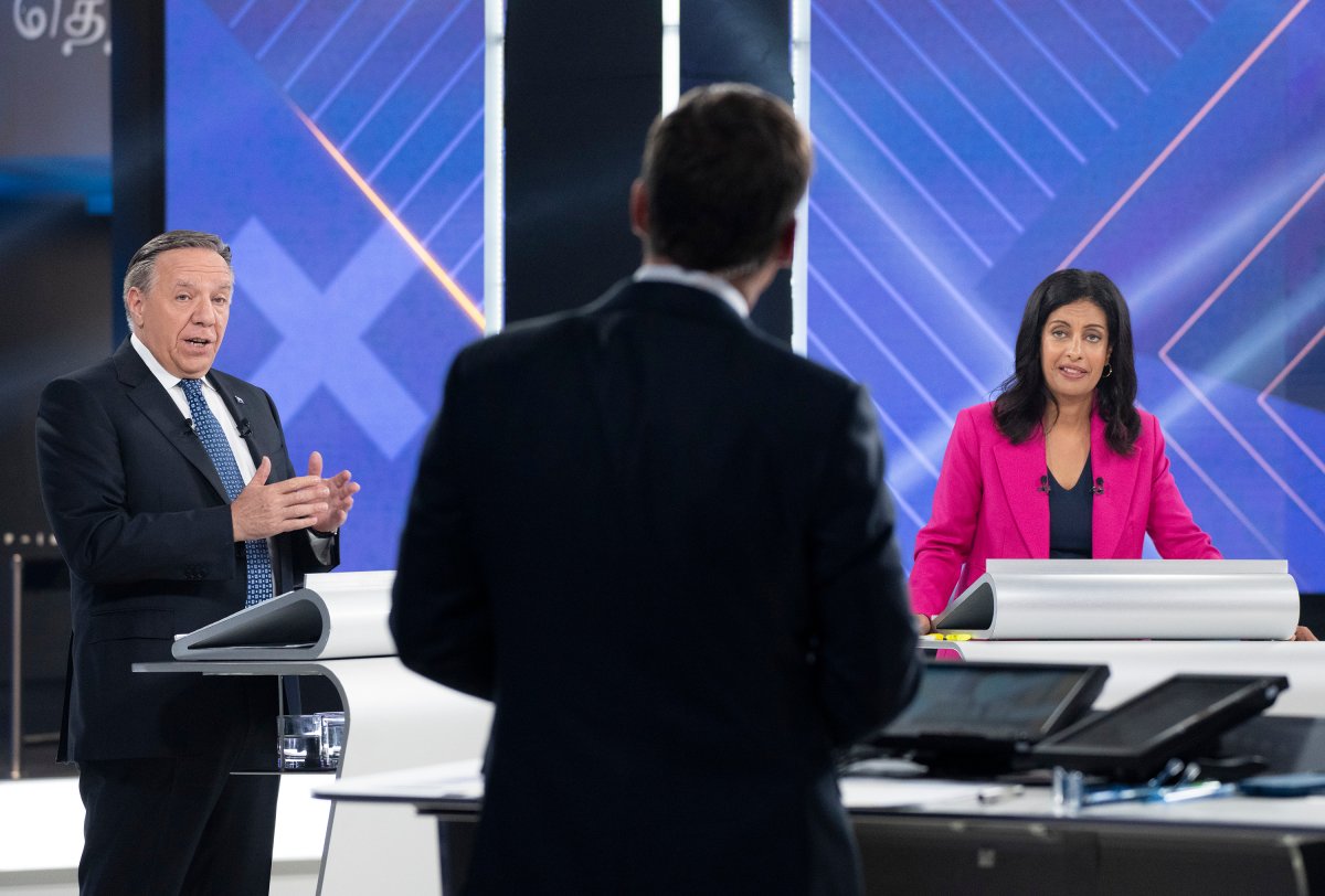 CAQ Leader Francois Legault and Liberal Leader Dominique Anglade look towards moderator Patrice Roy during a leaders debate in Montreal, Thursday, September 22, 2022. Quebecers will go to the polls on October 3rd.