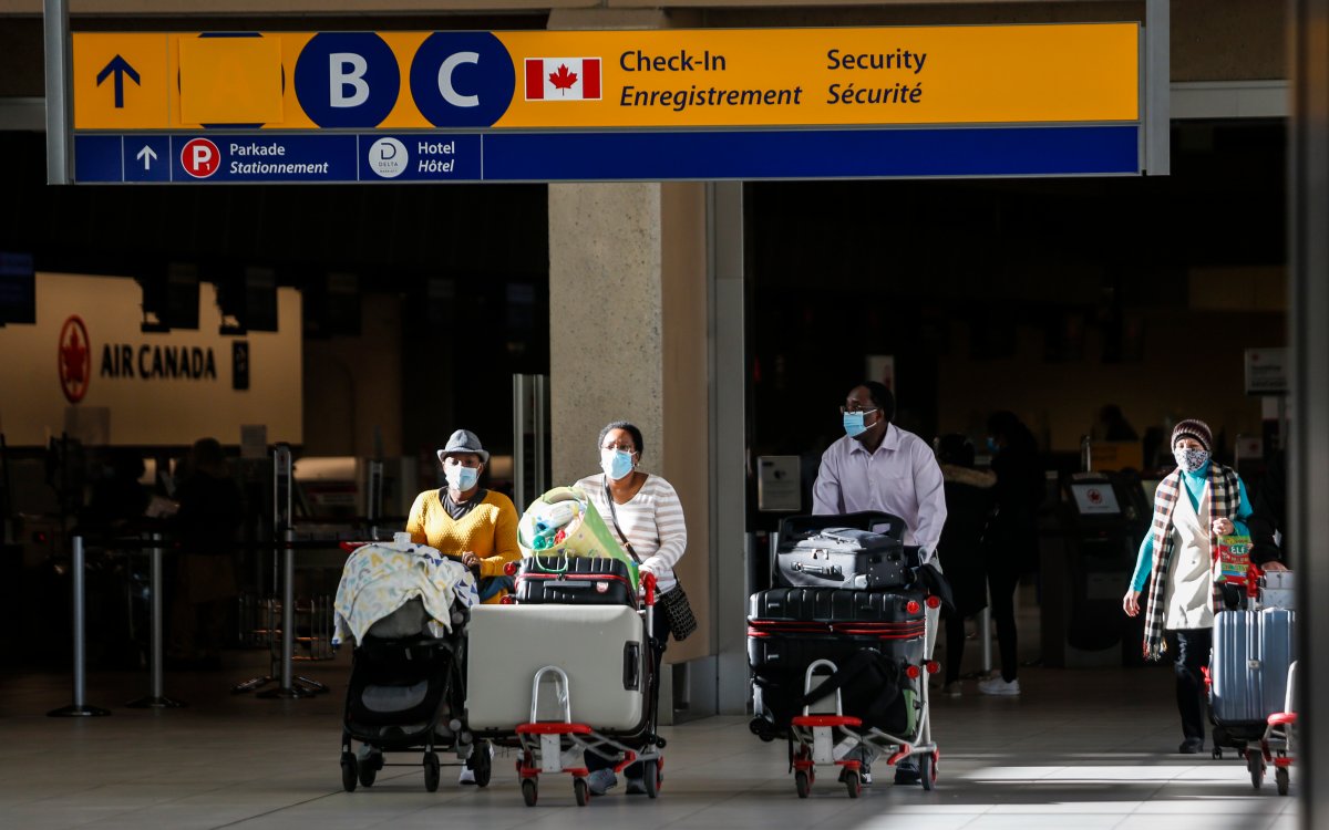 Passengers wear masks at the Calgary Airport in Calgary, Alta., Friday, Oct. 30, 2020.