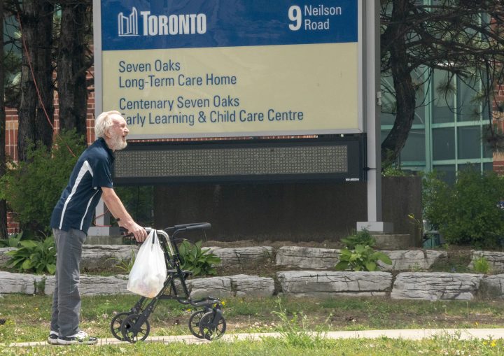 A man takes a walk outside the Seven Oaks Long-Term Care Home in Toronto on Thursday, June 25, 2020. 
