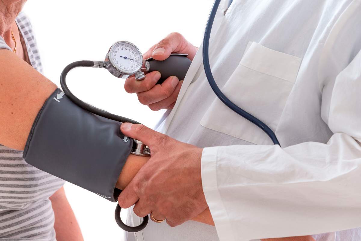 File: Close-up of a doctor taking blood pressure from a senior.