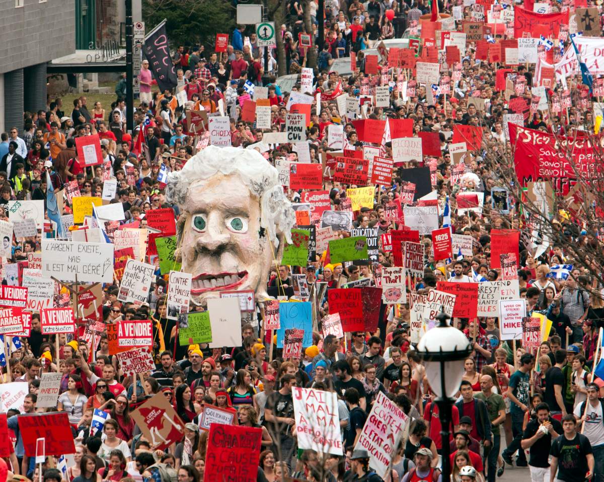Students carry an effigy of then Quebec Premier Jean Charest as they march through the streets of downtown in a massive protest against tuition fee hikes Thursday, March 22, 2012 in Montreal.
