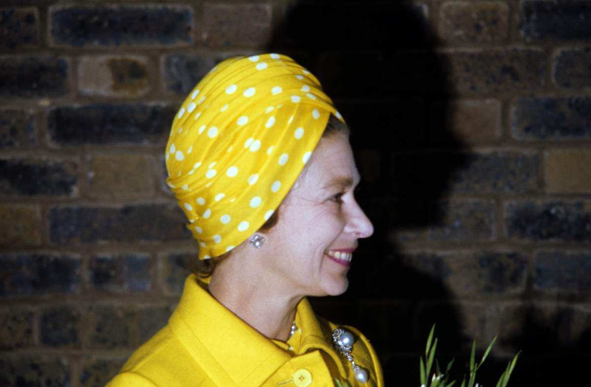 Queen Elizabeth II wears a polka-dot turban as she opens the Jubilee Garden in 1977.