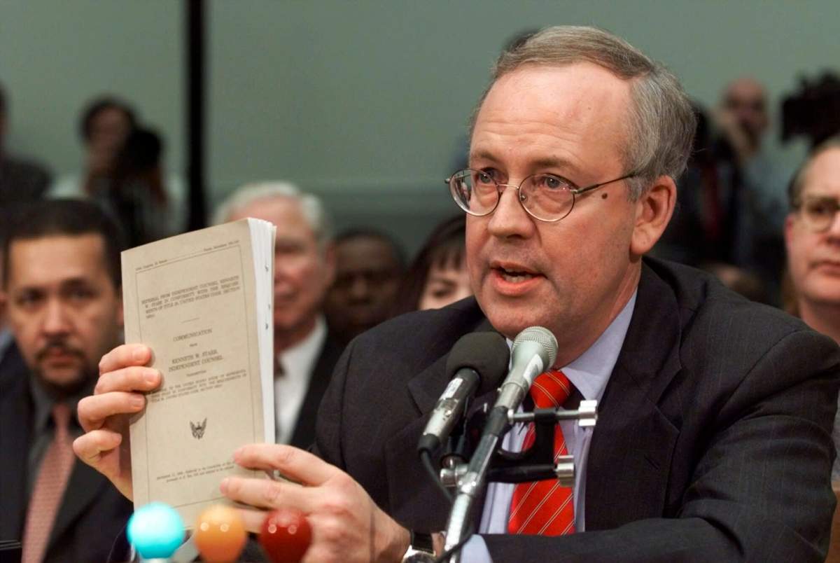 FILE – Independent Counsel Kenneth Starr holds a copy of his report while testifying on Capitol Hill Thursday Nov. 19, 1998, before the House Judiciary Committee’s impeachment hearing. Starr, whose criminal investigation of Bill Clinton led to the president’s impeachment, died Sept. 13, 2022. He was 76.(AP Photo/Doug Mills, File)
