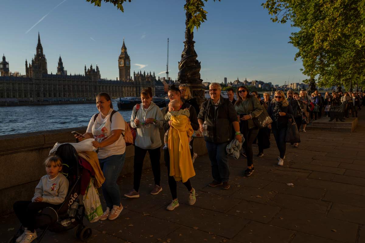 People queue to pay their respects to the late Queen Elizabeth II during the Lying-in State, outside Westminster Hall in London, Saturday, Sept. 17, 2022. (AP Photo/Emilio Morenatti)